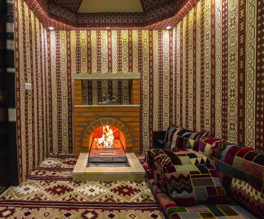Rest Night Serviced Apartments- Alhamra Riyadh Bagian luar foto A majlis with a fireplace